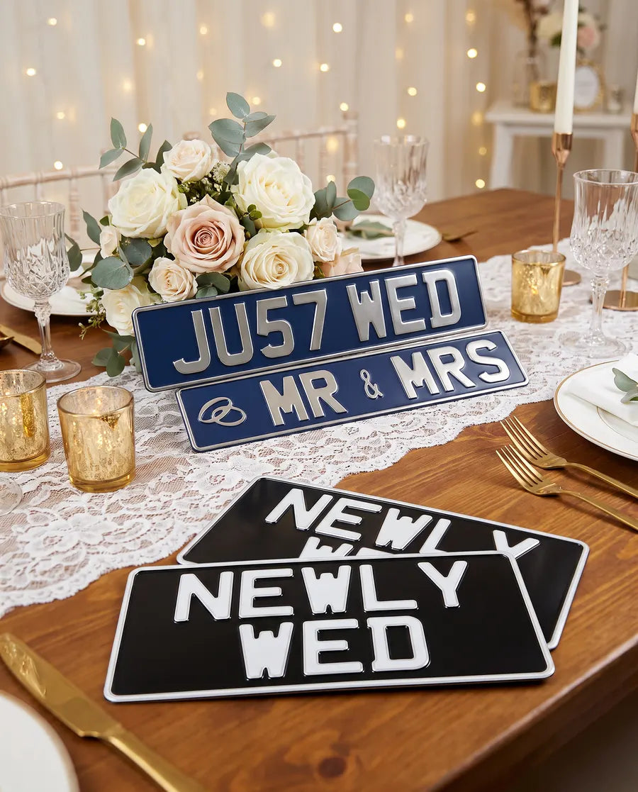 Wedding gift number plates reading JU57 WED, Mr & Mrs and Newly Wed on a reception table
