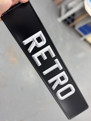 vintage number plate with the word 'retro' pressed into it 