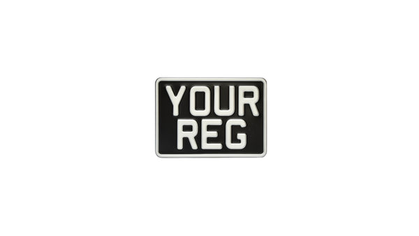 A black metal motorbike number plate with the text 'YOUR REG' on it.