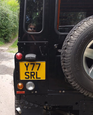 Black land rover with yellow pressed metal Land Rover license plate