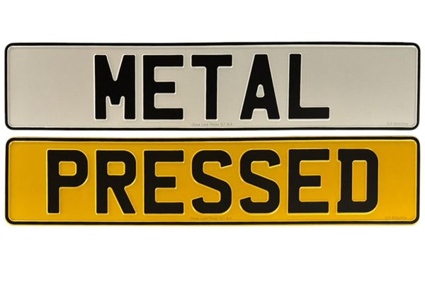 A metal pressed number plate with the words 'METAL' and 'PRESSED' displayed in a bold, black font against a white and yellow background.